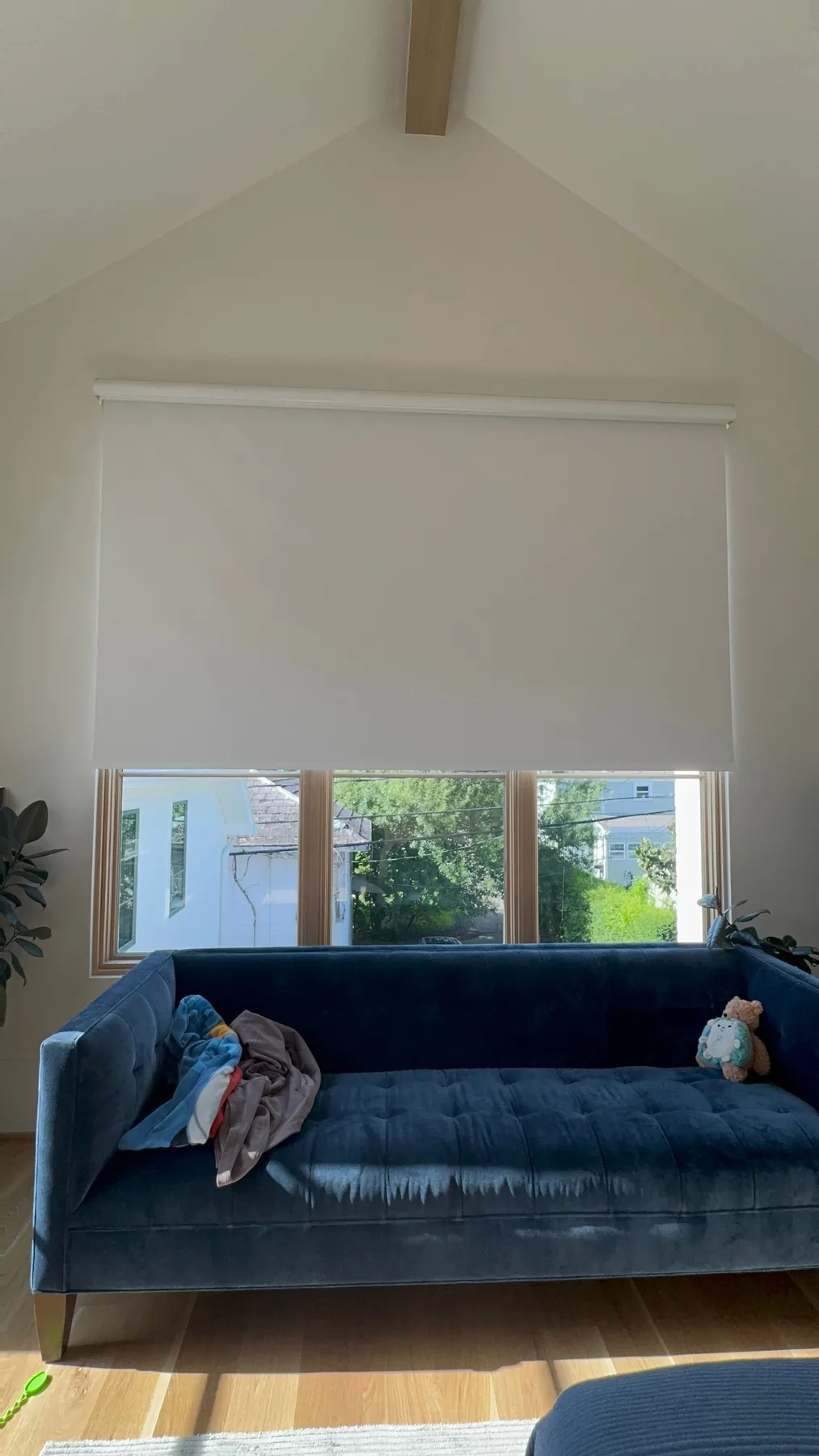 Light-filtering interior roller shade above a blue sofa
